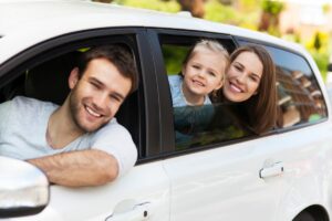 Family Smiling in Car with Car Insurance in Menifee, CA