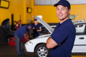 Man Standing in Auto Service Building with Small Business Insurance in Lake Elsinore, CA